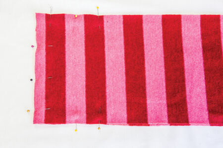 pink and red striped fabric pinned around all edges